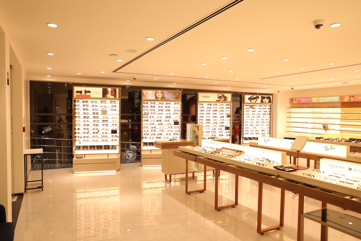 A stylish product display showcasing various eyeglasses on a flat surface with a clean background