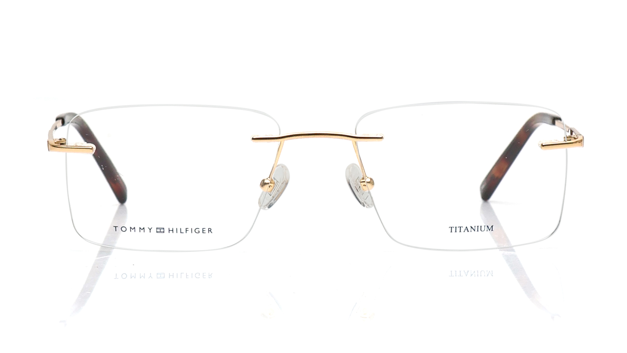 Image 1 of Gunmetal Rectangle Rimless Eyeglasses for Men and Women from Tommy Hilfiger Available at Titan Eye+